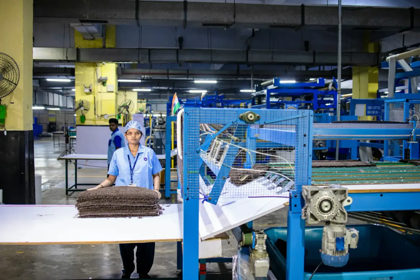 Technician monitoring an active industrial production line on the factory floor