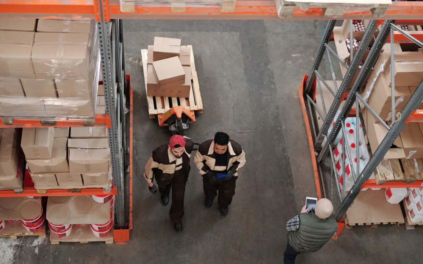 Stacked and labeled export cartons staged on pallets inside a logistics warehouse for consolidation