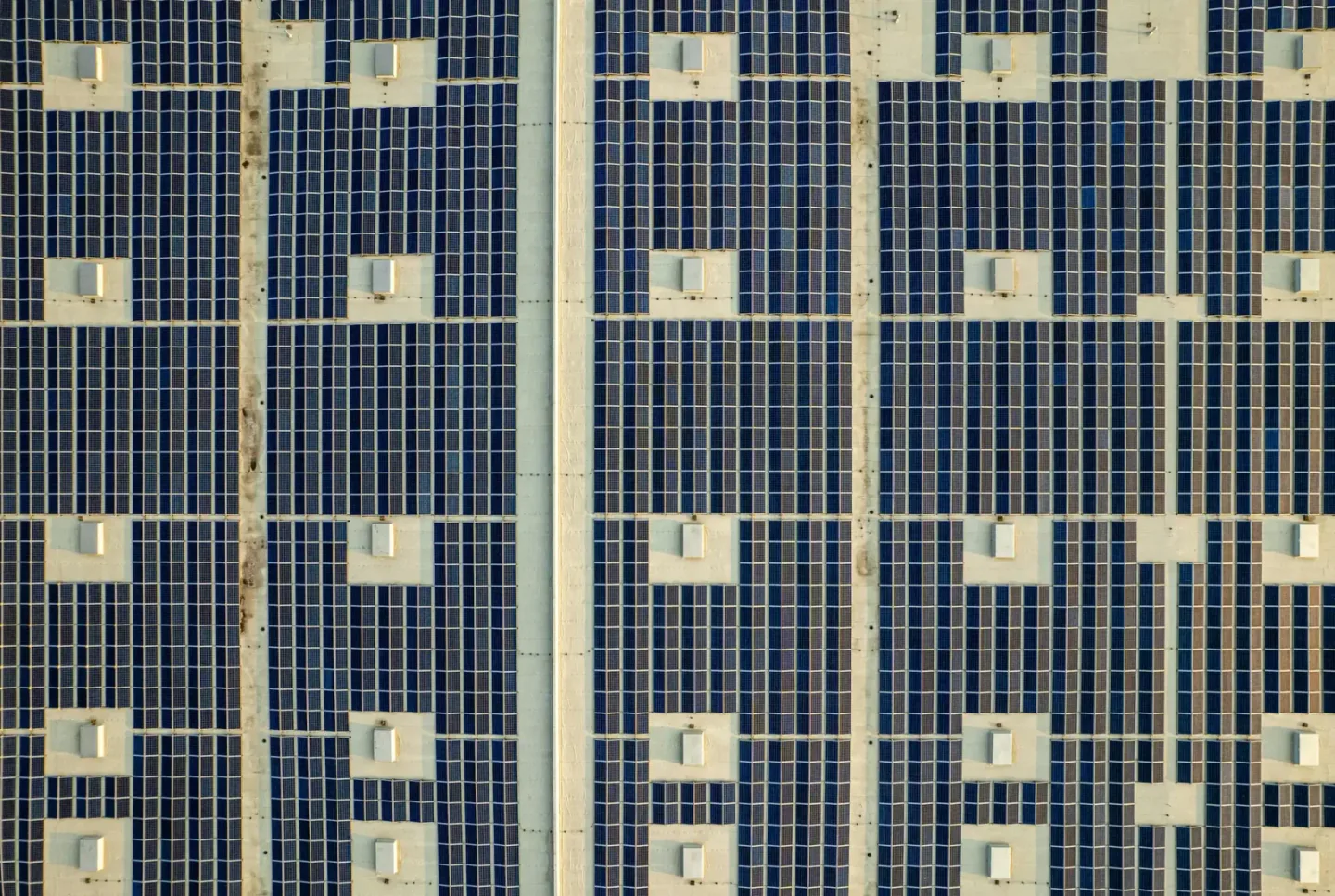 Arrays of solar photovoltaic panels installed across an industrial facility roof