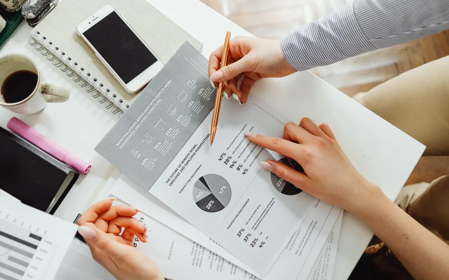 Comparing supplier quotations, technical drawings, and specification sheets on a worktable