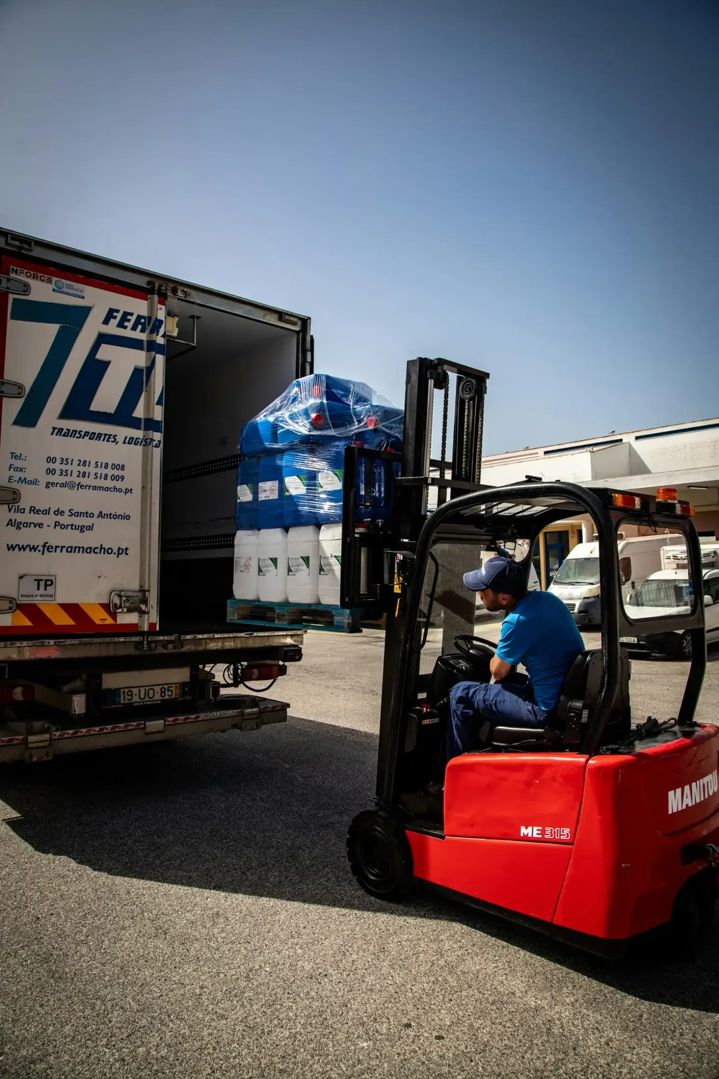 Forklift loading palletised cartons onto a commercial delivery truck after release